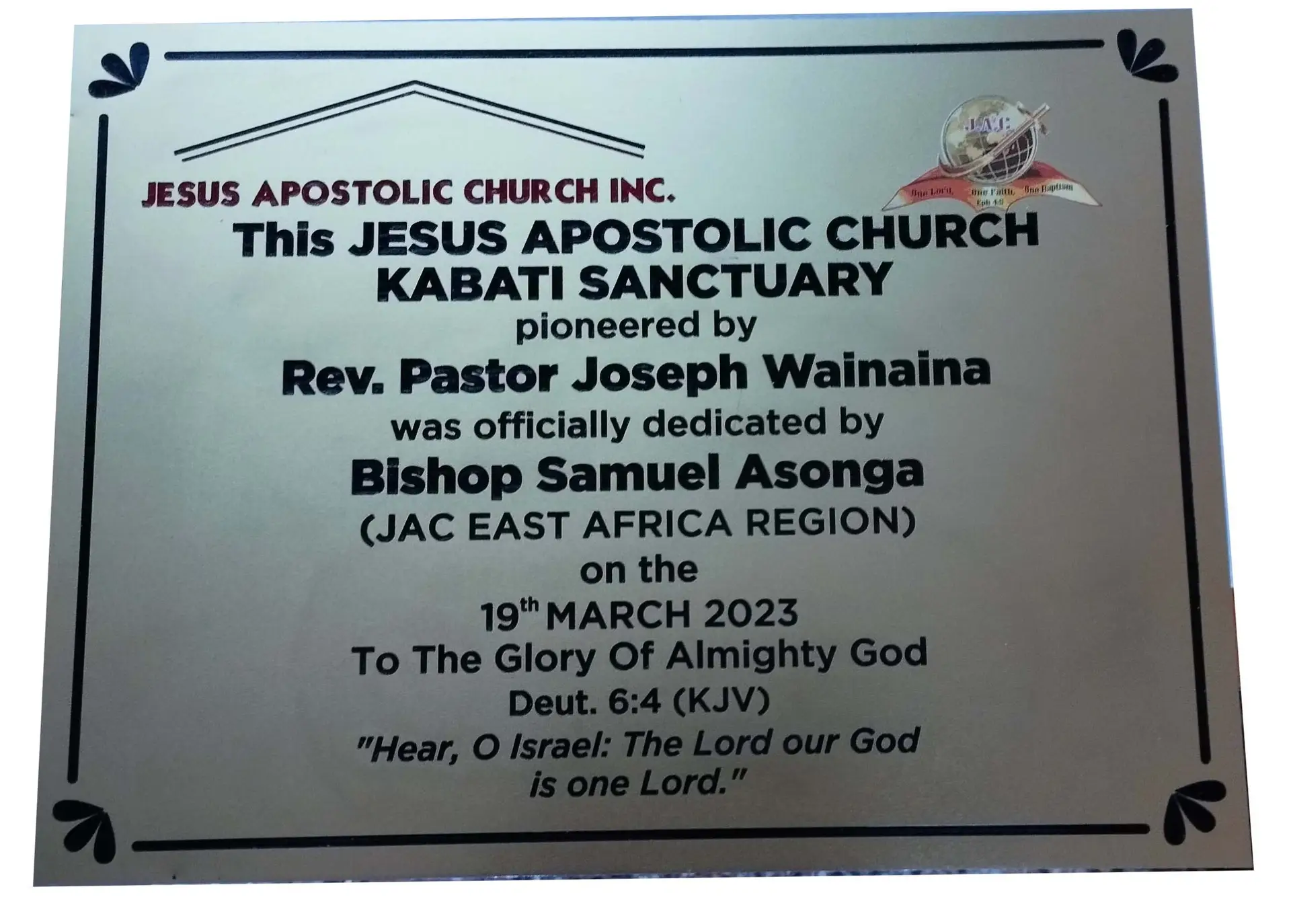 An aluminium engraved plaque commemorating the opening of a church
