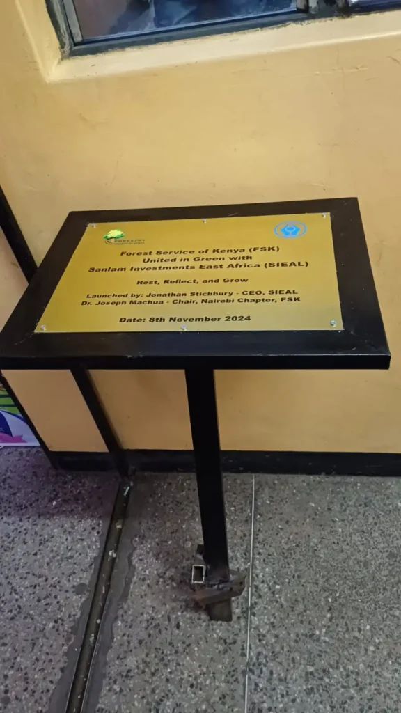 An engraved aluminium plaqe on a metal stand.