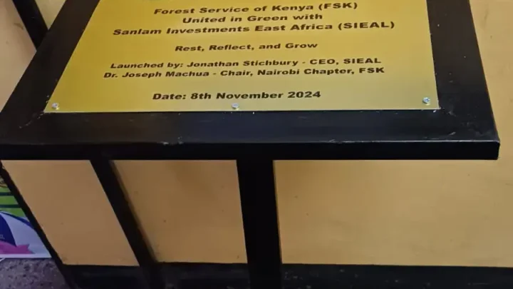 An engraved aluminium plaqe on a metal stand.