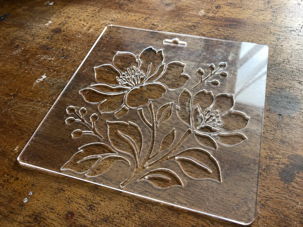 Laser-cut acrylic stencil with a floral pattern