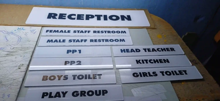 Door signs with reverse-printed clear sticker applied behind clear acrylic
