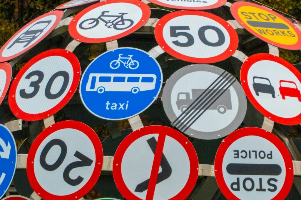 Assorted colour road signs on a pole